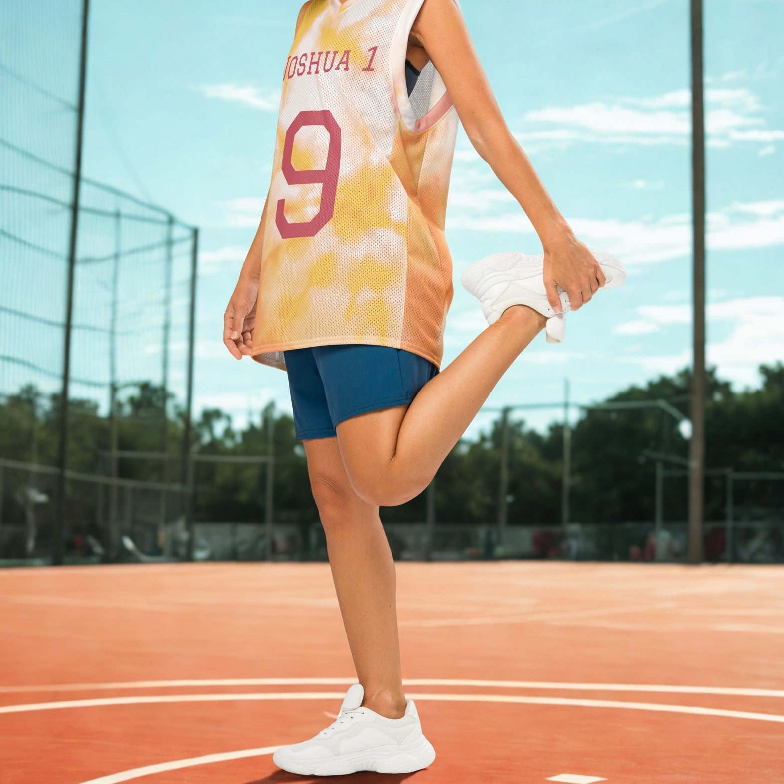 Woman in sports jersey and shorts on a basketball court